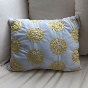 White decorative pillow with yellow flower pattern